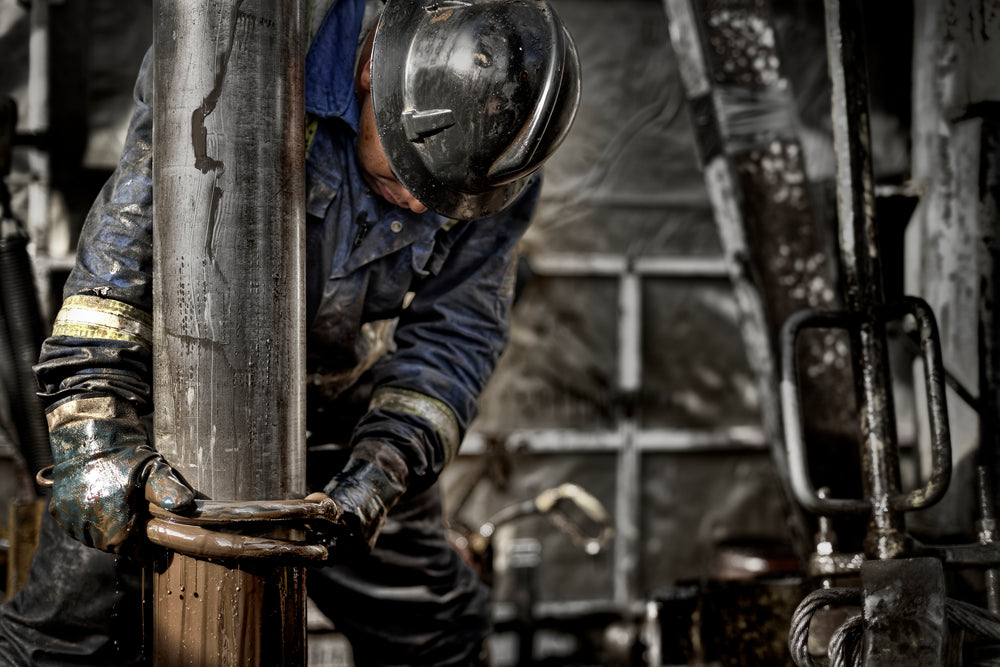 man in safety gear and hard hat works on a construction site