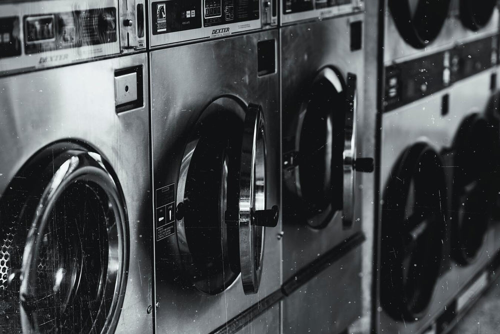 closeup black and white view of front loading washing machines